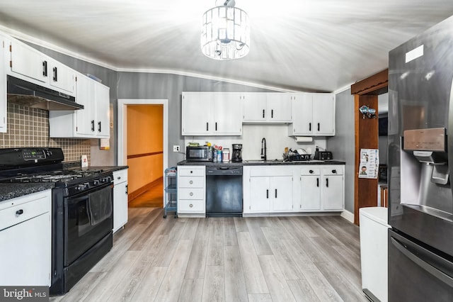 kitchen with black appliances, under cabinet range hood, a sink, dark countertops, and light wood finished floors