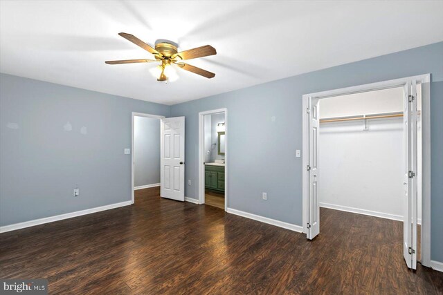 23115 Mt Cloud Rd, Bowling Green, VA 22427 - unfurnished bedroom with a walk in closet, wood finished floors, and baseboards