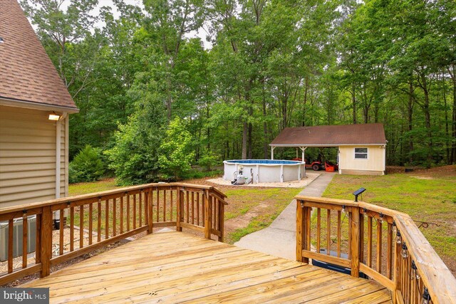 23115 Mt Cloud Rd, Bowling Green, VA 22427 - wooden deck featuring an outdoor pool and an outdoor structure