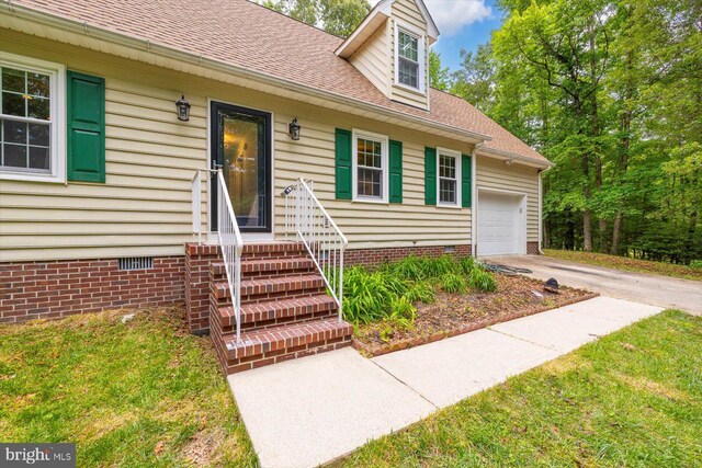 23115 Mt Cloud Rd, Bowling Green, VA 22427 - view of exterior entry featuring crawl space, driveway, a shingled roof, and a garage