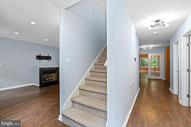 23115 Mt Cloud Rd, Bowling Green, VA 22427 - stairs featuring wood finished floors, a fireplace with flush hearth, recessed lighting, and baseboards
