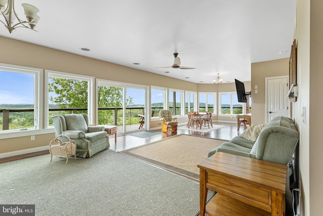 9207 Douglas Rd, Olanta, PA 16863 - living area with a chandelier, healthy amount of natural light, ceiling fan, and baseboards