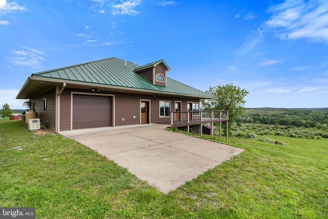 9207 Douglas Rd, Olanta, PA 16863 - view of front of property featuring an attached garage, a front lawn, driveway, metal roof, and a standing seam roof