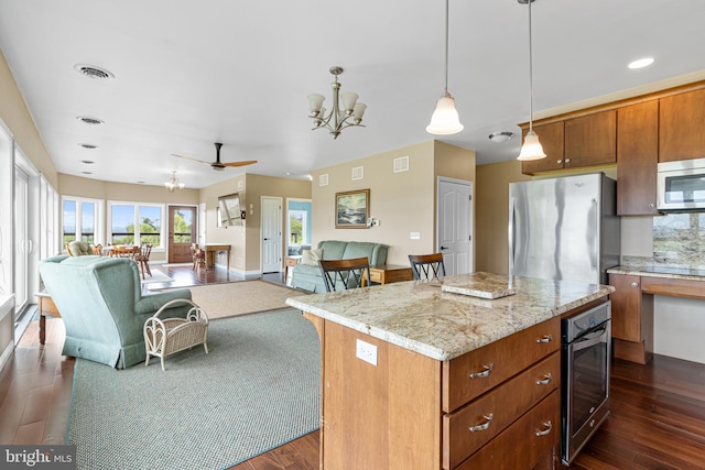 9207 Douglas Rd, Olanta, PA 16863 - kitchen featuring appliances with stainless steel finishes, open floor plan, a chandelier, dark wood-style floors, and recessed lighting