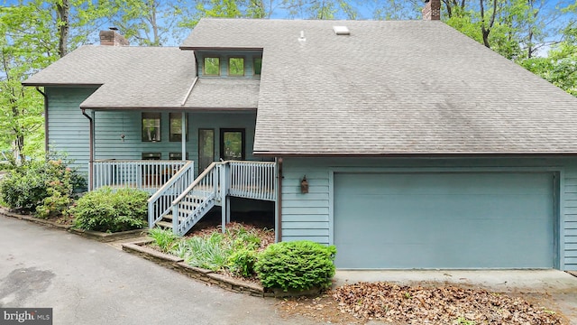 200 Sunset Cir, Cross Junction, VA 22625 - view of front facade with a chimney, a shingled roof, a porch, and a garage