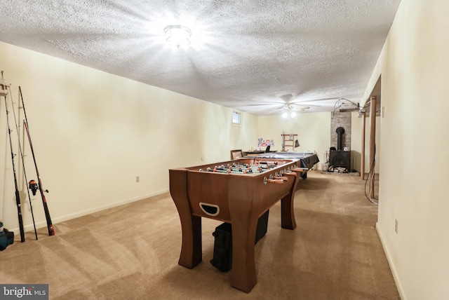 200 Sunset Cir, Cross Junction, VA 22625 - rec room featuring carpet flooring, a wood stove, a textured ceiling, and baseboards