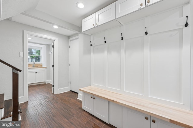 mudroom featuring recessed lighting, baseboards, and dark wood-style flooring