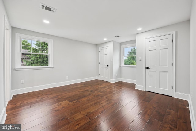 unfurnished room with dark wood-style flooring, baseboards, and recessed lighting