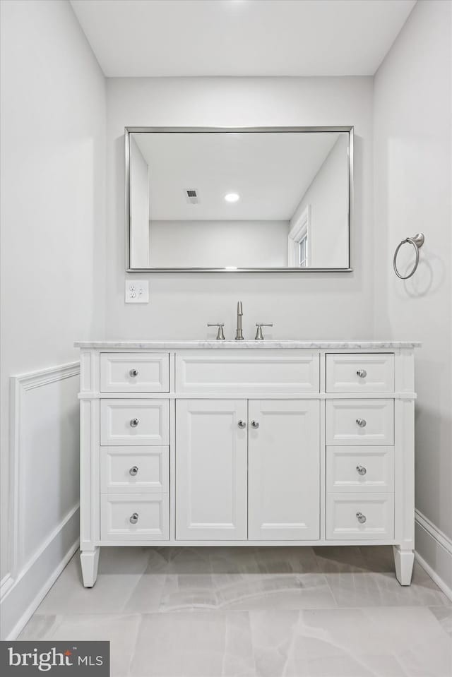 bathroom with vanity and baseboards