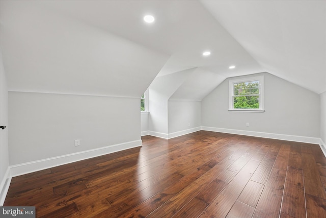 additional living space with lofted ceiling, wood-type flooring, baseboards, and recessed lighting