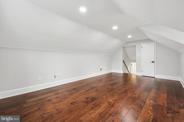 additional living space with lofted ceiling, wood-type flooring, baseboards, and recessed lighting
