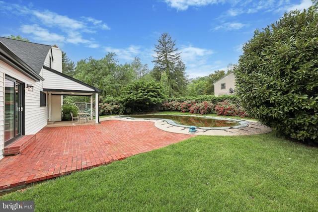 view of grassy yard with a patio