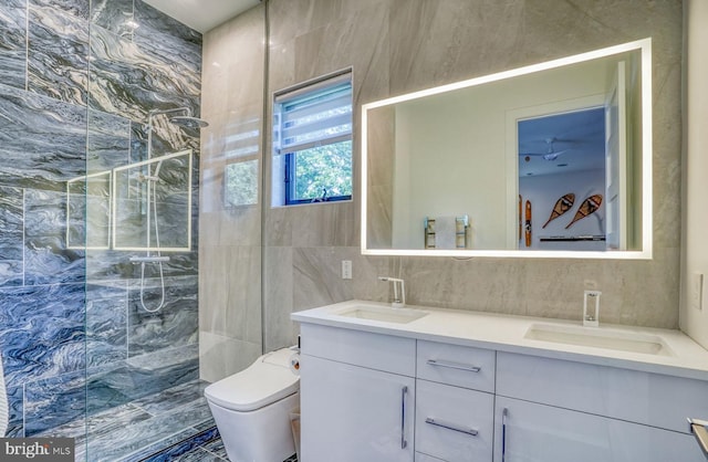 104 W Buckingham Dr, Rehoboth Beach, DE 19971 - bathroom featuring tile walls, walk in shower, double vanity, and toilet