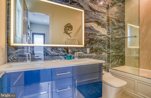 104 W Buckingham Dr, Rehoboth Beach, DE 19971 - bathroom with double vanity,  shower combination, toilet, and tile walls