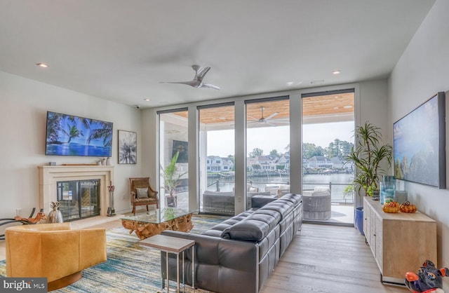 104 W Buckingham Dr, Rehoboth Beach, DE 19971 - living area with ceiling fan, floor to ceiling windows, light wood-style flooring, a glass covered fireplace, and recessed lighting