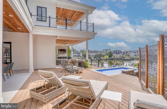 104 W Buckingham Dr, Rehoboth Beach, DE 19971 - deck with an outdoor kitchen, ceiling fan, a water view, and an outdoor pool