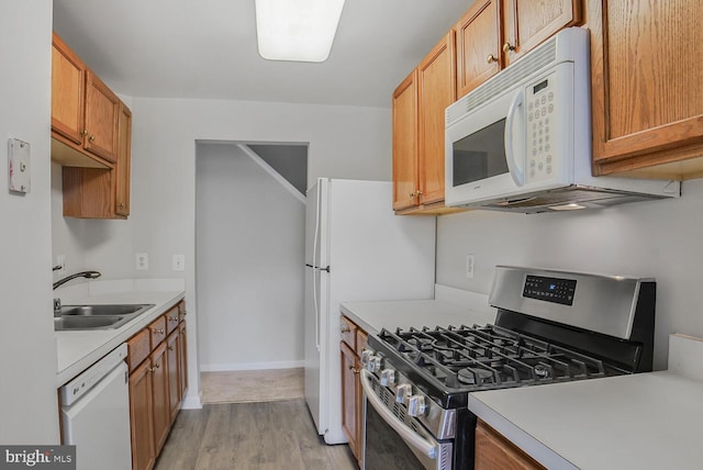 6510 Lake Park Dr Unit 2E/201, Greenbelt, MD 20770 - kitchen featuring white appliances, a sink, light countertops, and light wood-style floors