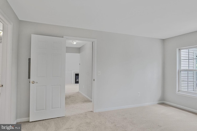 6510 Lake Park Dr Unit 2E/201, Greenbelt, MD 20770 - carpeted empty room with baseboards, a glass covered fireplace, and a smoke detector