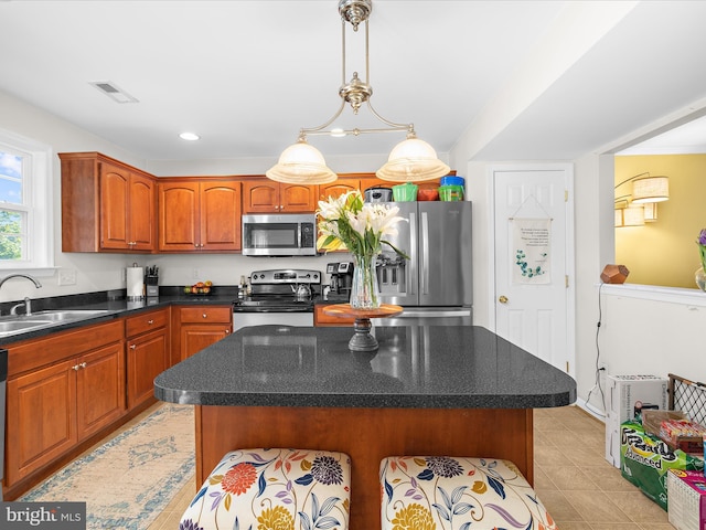 7737 Overhill Rd, Glen Burnie, MD 21060 - kitchen with appliances with stainless steel finishes, a sink, light tile patterned floors, a center island, and hanging light fixtures