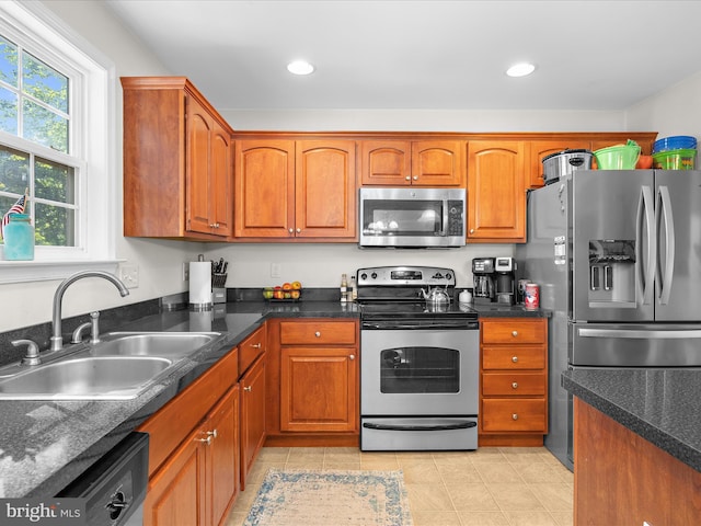 7737 Overhill Rd, Glen Burnie, MD 21060 - kitchen featuring appliances with stainless steel finishes, a sink, brown cabinets, light tile patterned floors, and recessed lighting