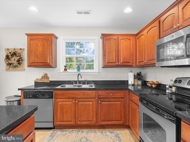 7737 Overhill Rd, Glen Burnie, MD 21060 - kitchen featuring stainless steel appliances, a sink, recessed lighting, dark countertops, and brown cabinets