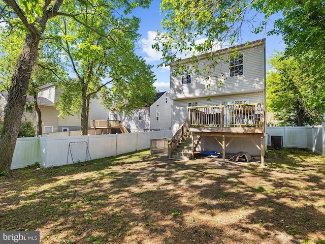 7737 Overhill Rd, Glen Burnie, MD 21060 - back of property with a deck, a fenced backyard, stairway, and central AC unit