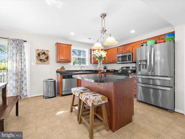 7737 Overhill Rd, Glen Burnie, MD 21060 - kitchen with appliances with stainless steel finishes, a kitchen island, baseboards, decorative light fixtures, and recessed lighting