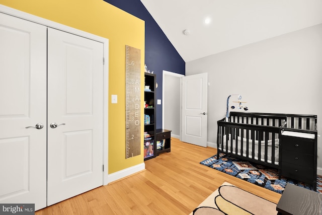 4521 Clay St NE, Washington, DC 20019 - bedroom with wood finished floors, baseboards, high vaulted ceiling, a crib, and a closet