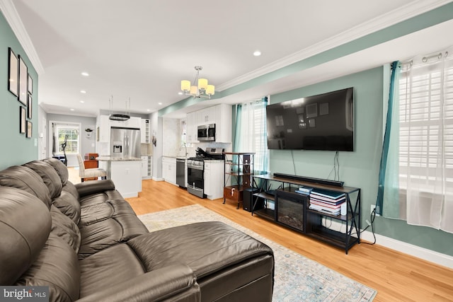 4521 Clay St NE, Washington, DC 20019 - living room featuring ornamental molding, a chandelier, light wood-type flooring, recessed lighting, and baseboards