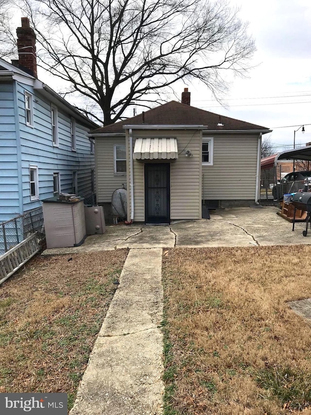833 Eastern Ave, Fairmount Heights, MD 20743 - back of property featuring a chimney and a patio area