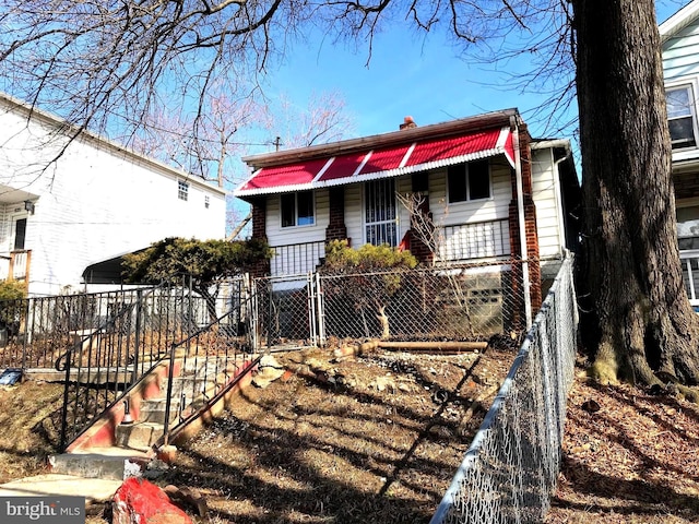833 Eastern Ave, Fairmount Heights, MD 20743 - view of front of house featuring covered porch, a chimney, a fenced front yard, and a gate