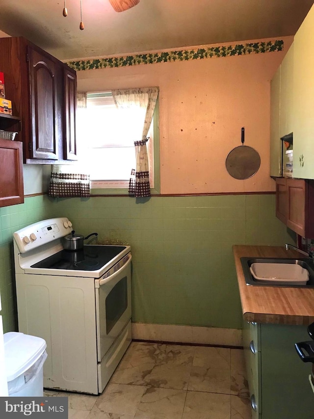 833 Eastern Ave, Fairmount Heights, MD 20743 - laundry room with a sink, tile walls, light marble finish flooring, and wainscoting