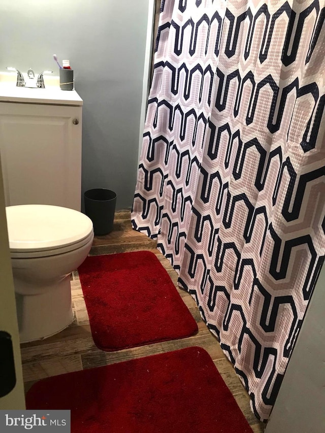 833 Eastern Ave, Fairmount Heights, MD 20743 - bathroom with toilet, a shower with shower curtain, wood finished floors, and vanity