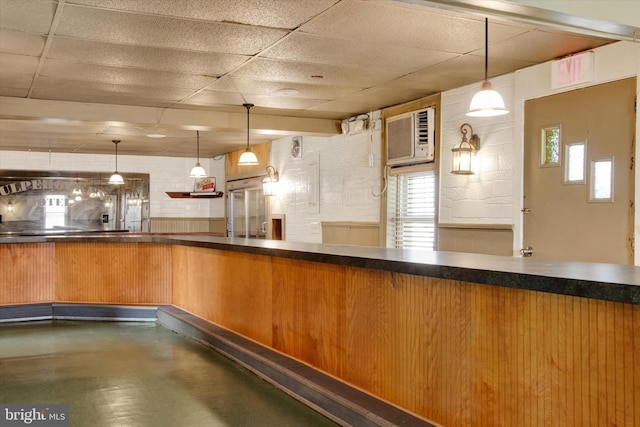 166 Tulpehocken St, Bernville, PA 19506 - kitchen with a drop ceiling, built in fridge, hanging light fixtures, a wall unit AC, and dark countertops