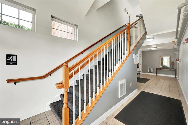 1050 Crest Way Unit 403, York, PA 17403 - staircase with tile patterned floors, a high ceiling, and baseboards