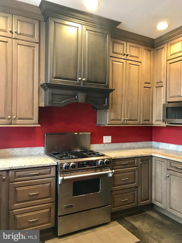 2205 E Baltimore St, Baltimore, MD 21231 - kitchen featuring stainless steel appliances, custom exhaust hood, and light stone countertops