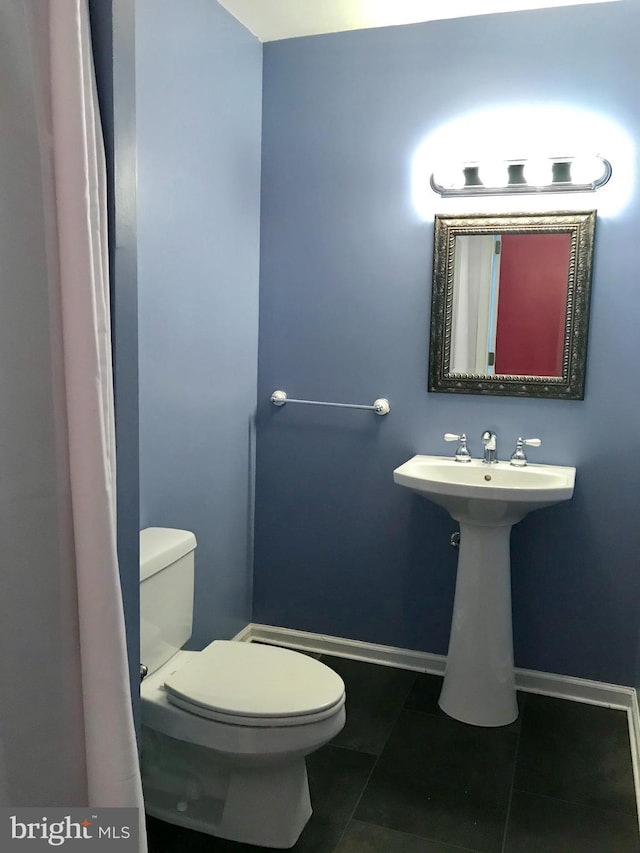 2205 E Baltimore St, Baltimore, MD 21231 - bathroom with toilet, tile patterned floors, and baseboards
