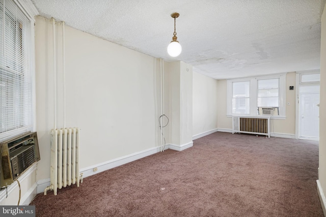 862 E Schiller St, Philadelphia, PA 19134 - unfurnished living room with radiator heating unit, carpet flooring, a textured ceiling, cooling unit, and baseboards