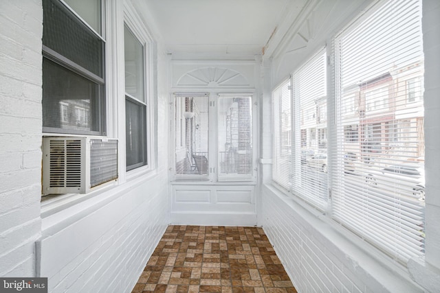 862 E Schiller St, Philadelphia, PA 19134 - unfurnished sunroom featuring brick patterned floors, cooling unit, and a decorative wall