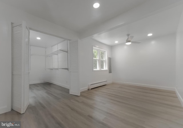 empty room featuring a baseboard heating unit, wood finished floors, a ceiling fan, recessed lighting, and baseboards