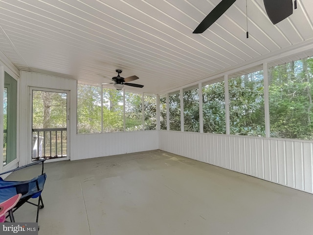 unfurnished sunroom with a ceiling fan