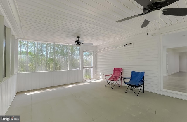 unfurnished sunroom with a ceiling fan