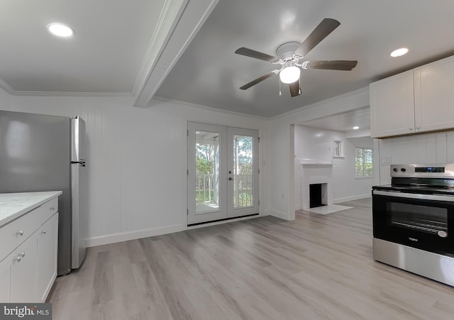 kitchen featuring appliances with stainless steel finishes, light wood-style flooring, crown molding, a ceiling fan, and beamed ceiling