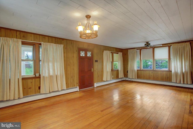 38 Mountain Rd, Orrtanna, PA 17353 - foyer entrance featuring plenty of natural light, hardwood / wood-style flooring, a baseboard radiator, a chandelier, and wooden walls