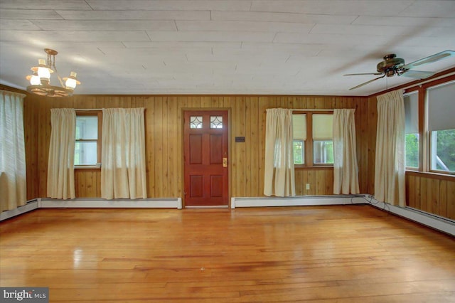 38 Mountain Rd, Orrtanna, PA 17353 - foyer featuring plenty of natural light, a chandelier, wood-type flooring, a baseboard radiator, and wooden walls