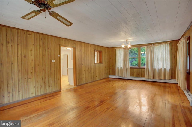 38 Mountain Rd, Orrtanna, PA 17353 - empty room featuring wood-type flooring, a chandelier, wooden walls, a ceiling fan, and a baseboard radiator