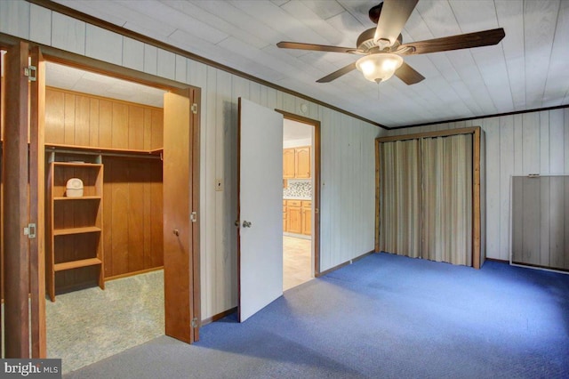 38 Mountain Rd, Orrtanna, PA 17353 - unfurnished bedroom featuring carpet flooring, ornamental molding, wooden walls, ensuite bathroom, and ceiling fan