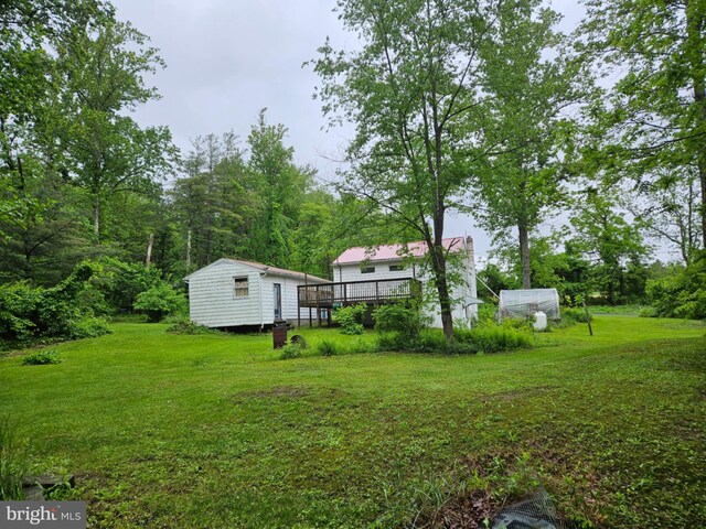 38 Mountain Rd, Orrtanna, PA 17353 - view of green lawn with an outbuilding, a greenhouse, and a wooden deck