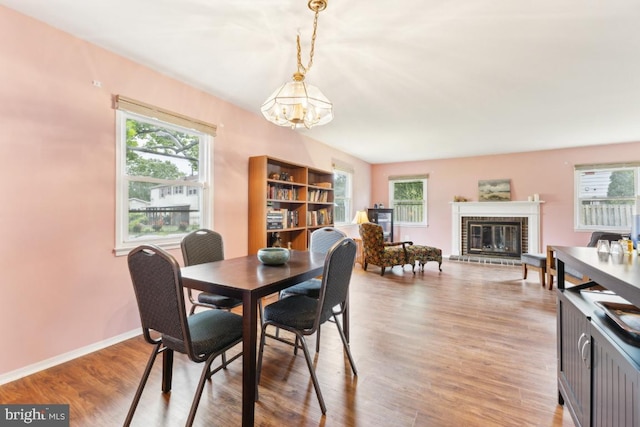4105 Majestic Ln, Fairfax, VA 22033 - dining space featuring a chandelier, plenty of natural light, light wood-style flooring, and a fireplace