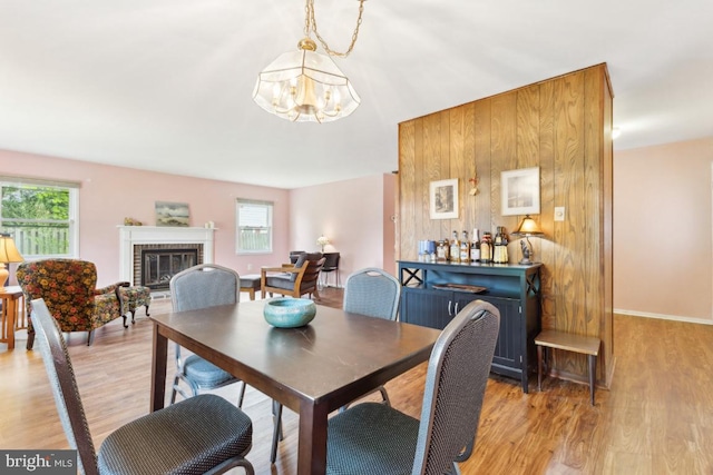 4105 Majestic Ln, Fairfax, VA 22033 - dining area featuring a chandelier, healthy amount of natural light, light wood-style floors, and a fireplace